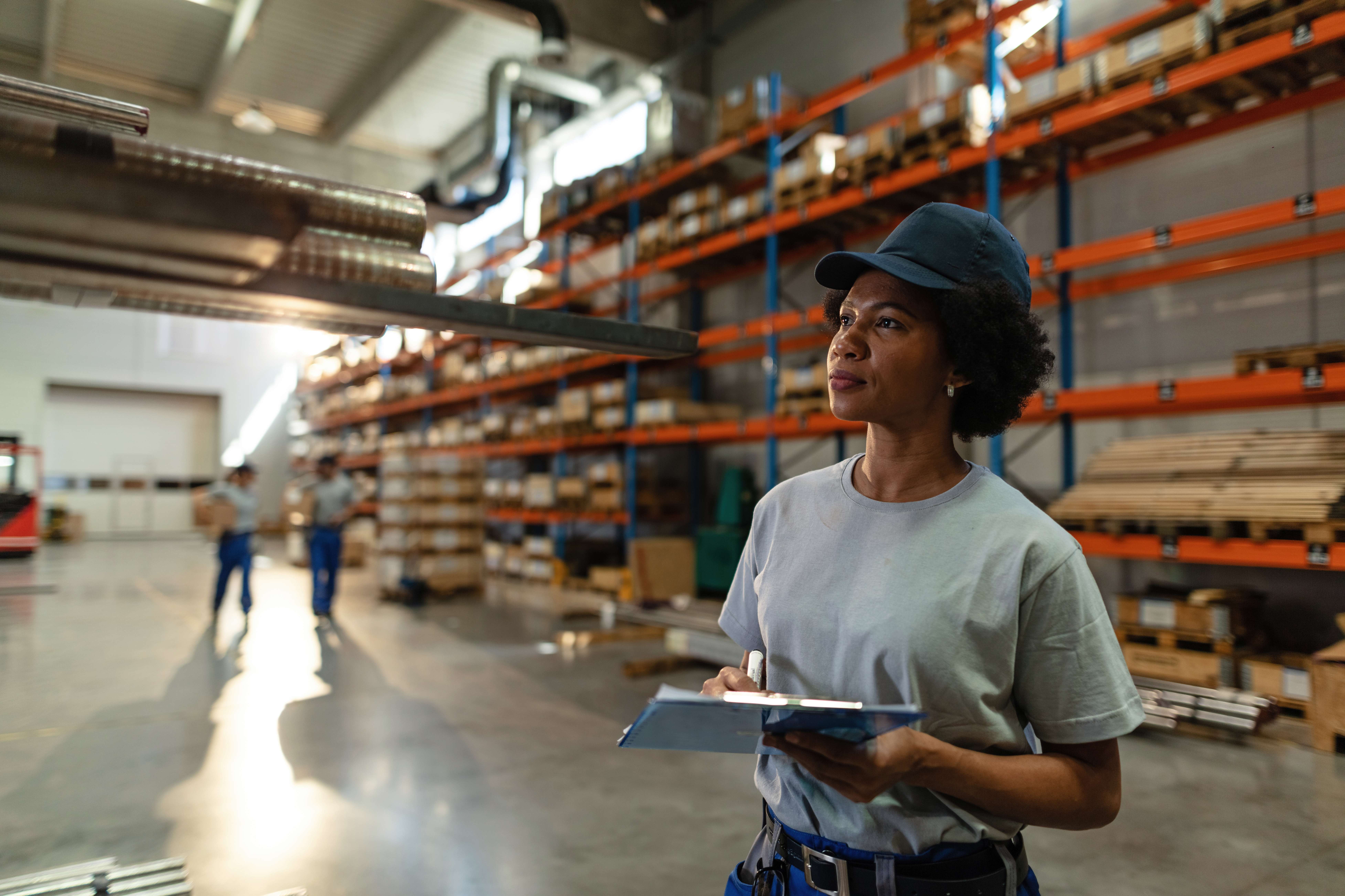 african-american-female-worker-taking-notes-while-inspecting-steel-products-warehouse (1)